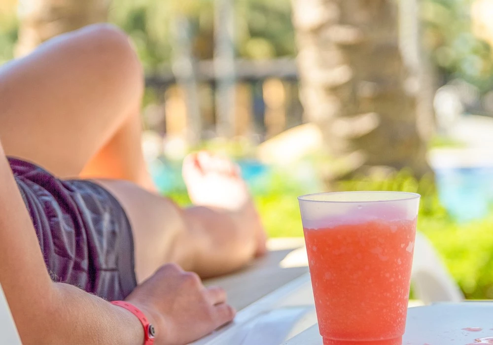 a person lying on a table with a drink