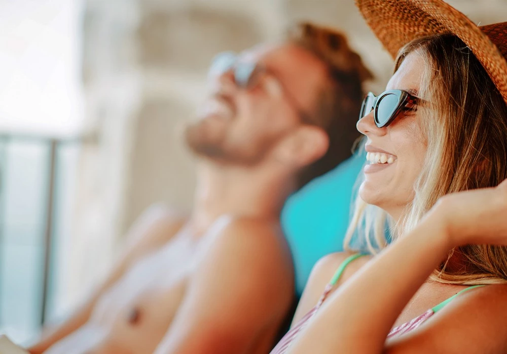 a man and woman in swimsuits and sunglasses