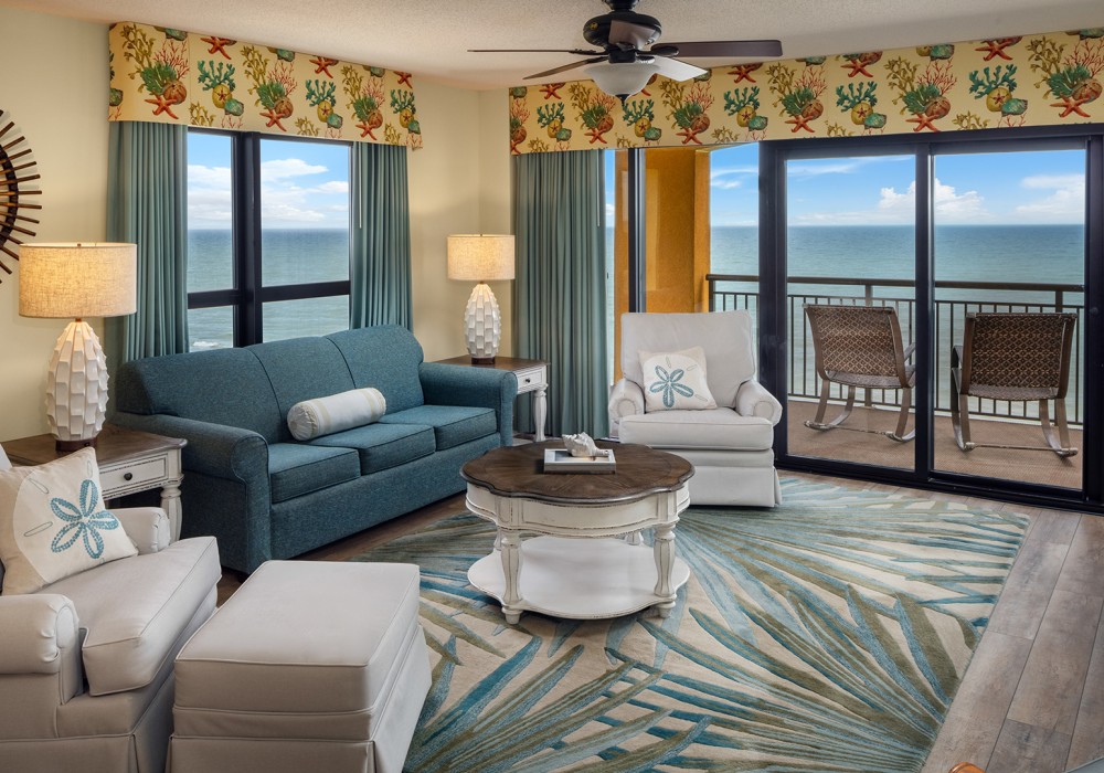 a living room with a view of the ocean