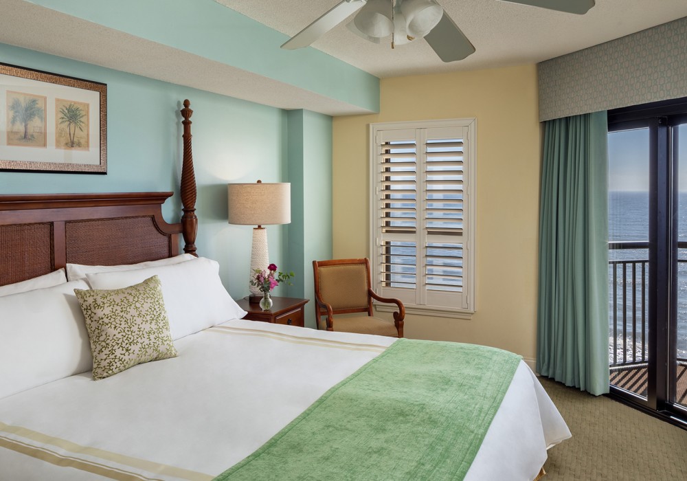 a bedroom with a white bed and a lamp