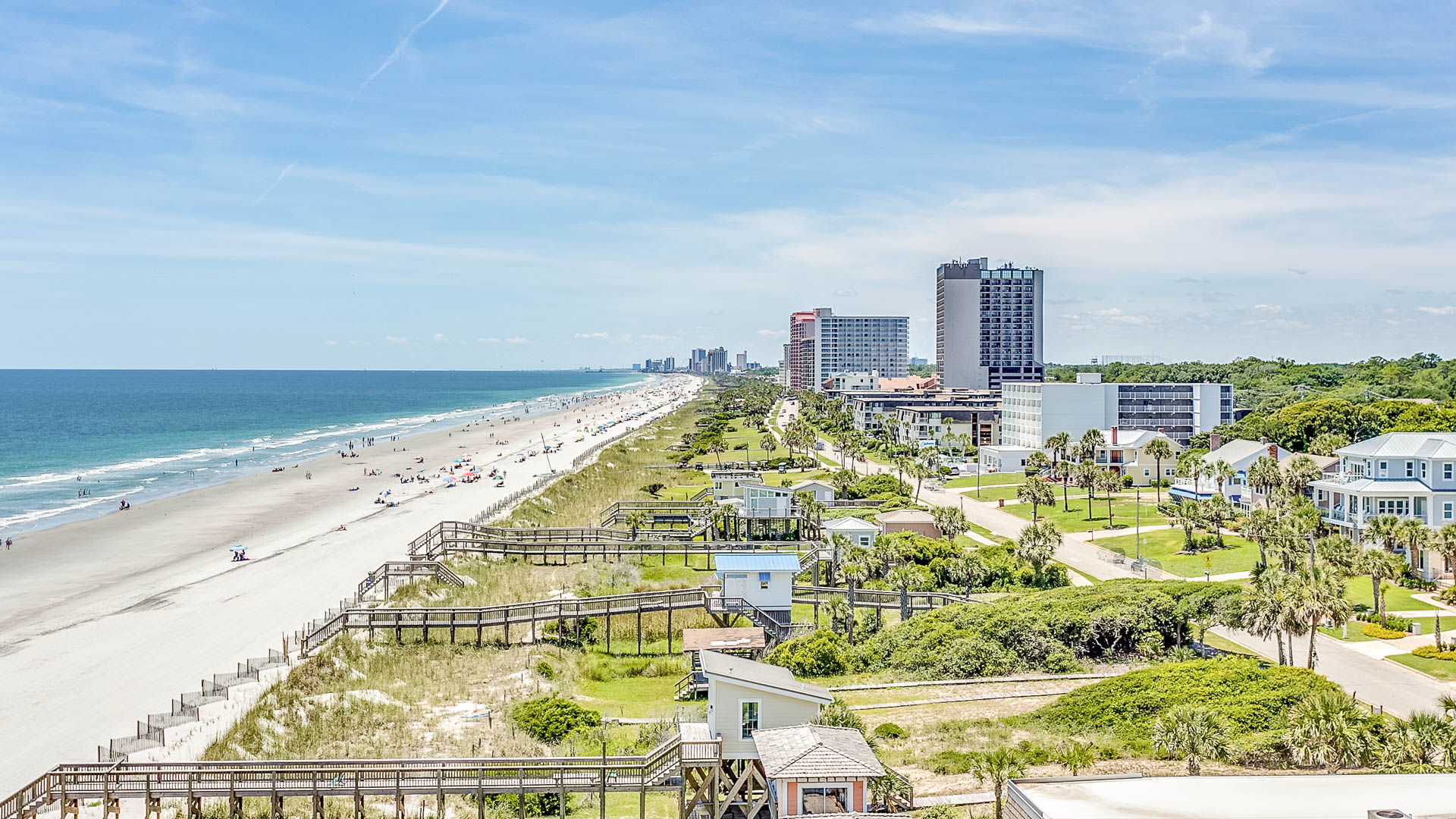 a beach with buildings and a body of water