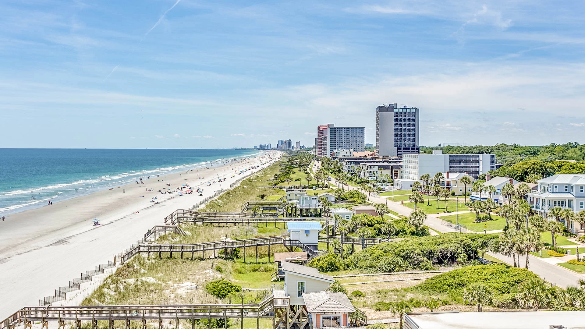 a beach with buildings and a body of water