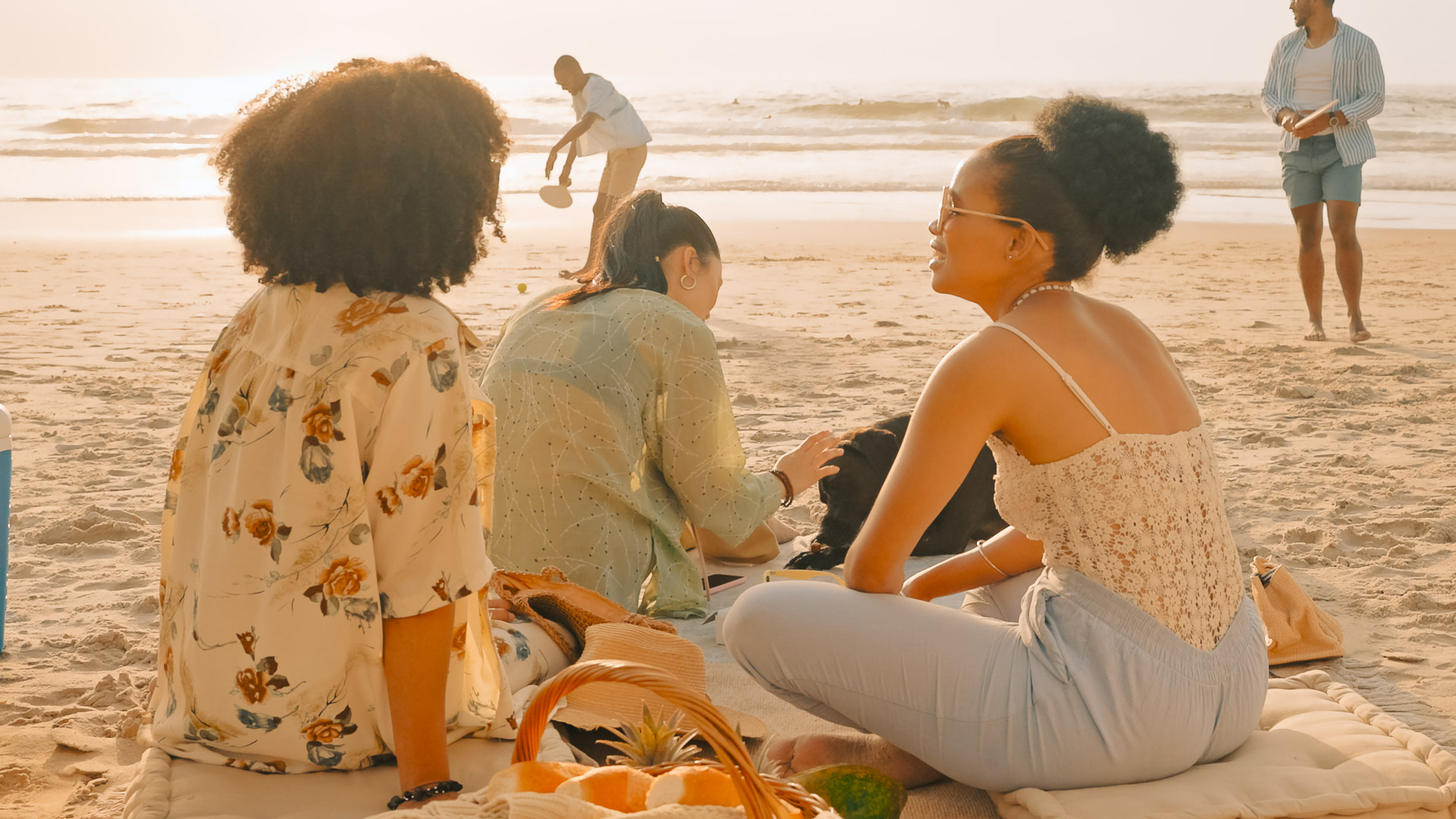 a group of people sitting on a beach