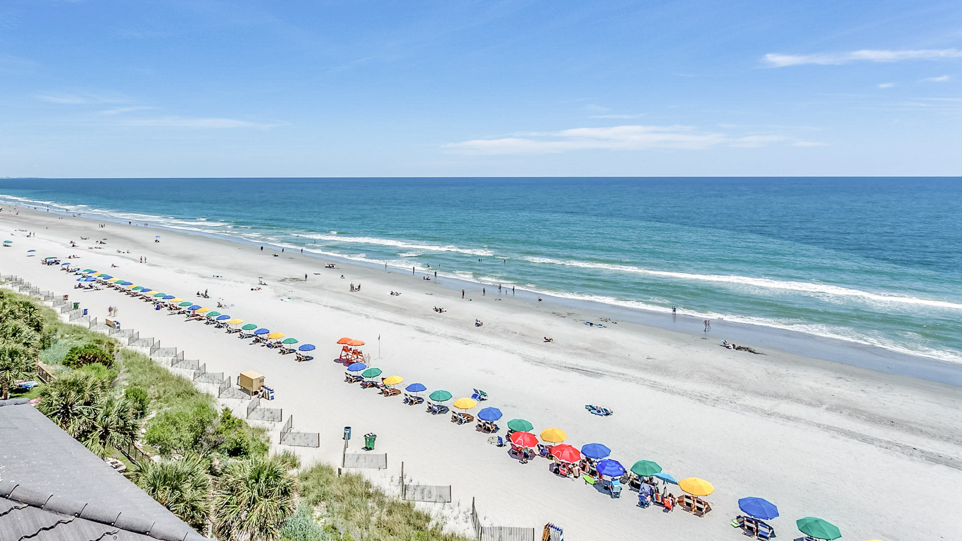 a beach with umbrellas and people on it