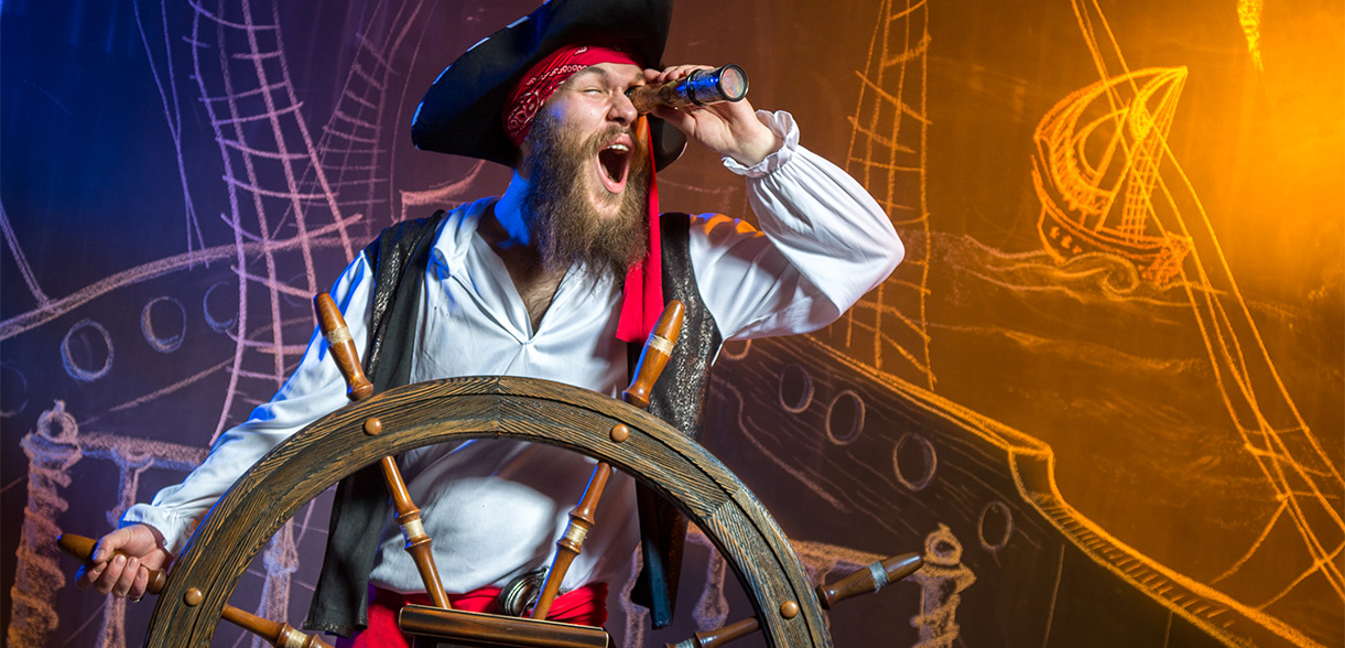 a man in a pirate garment with a telescope