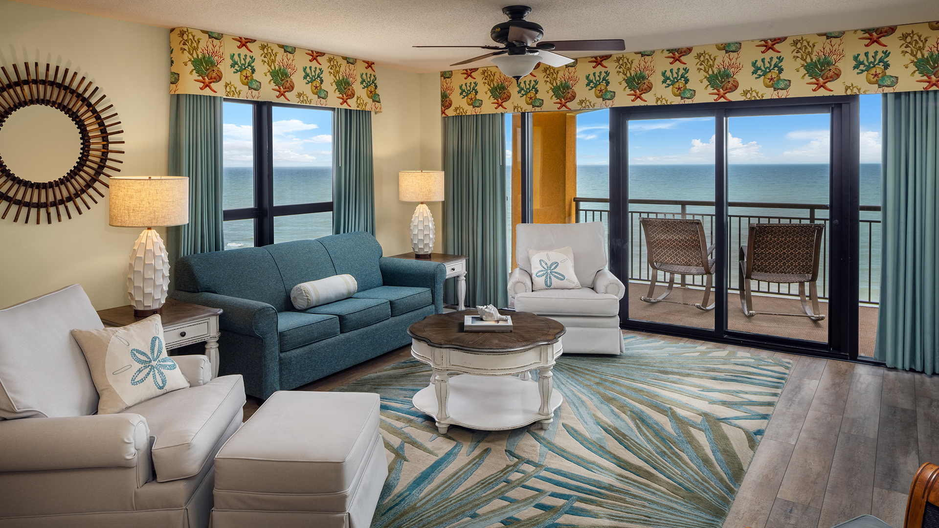 a living room with a view of the ocean