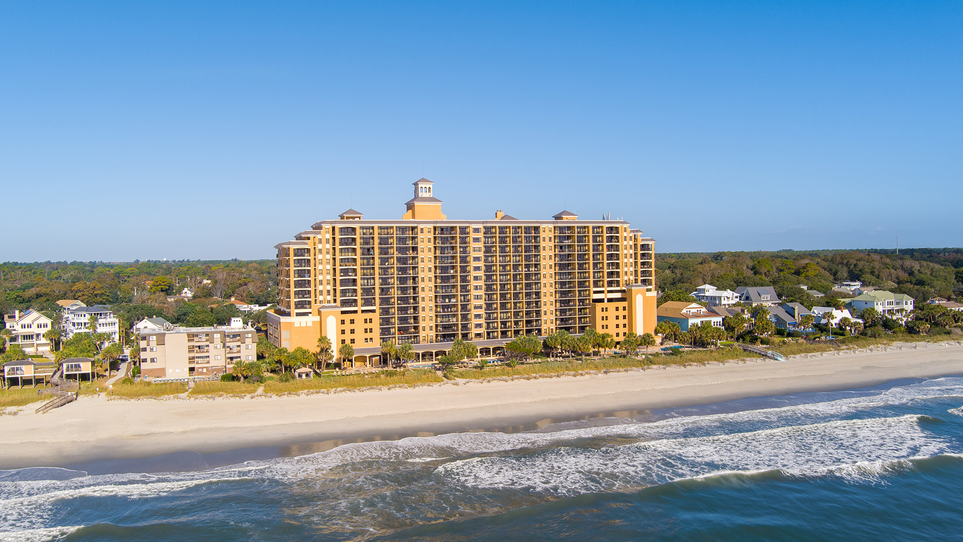 a large building next to a beach
