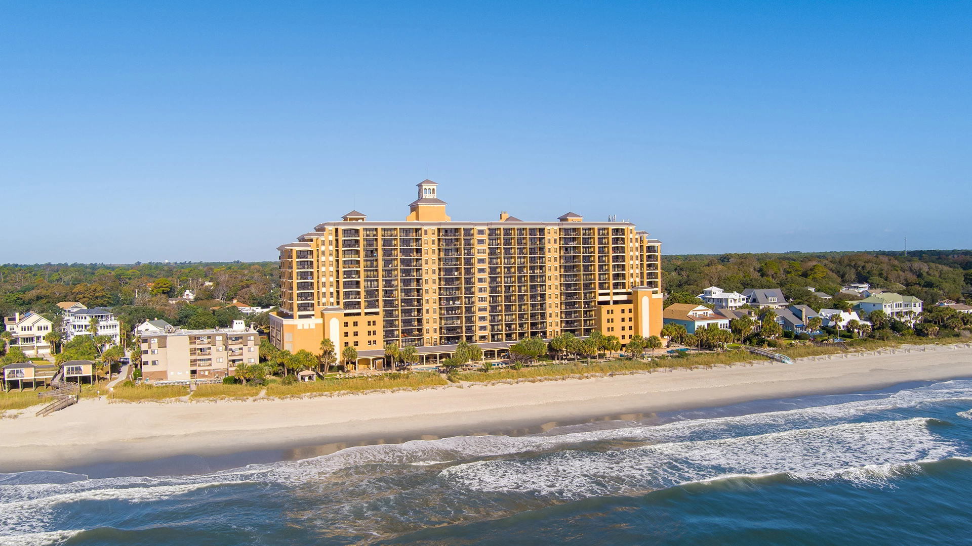 a large building next to a beach