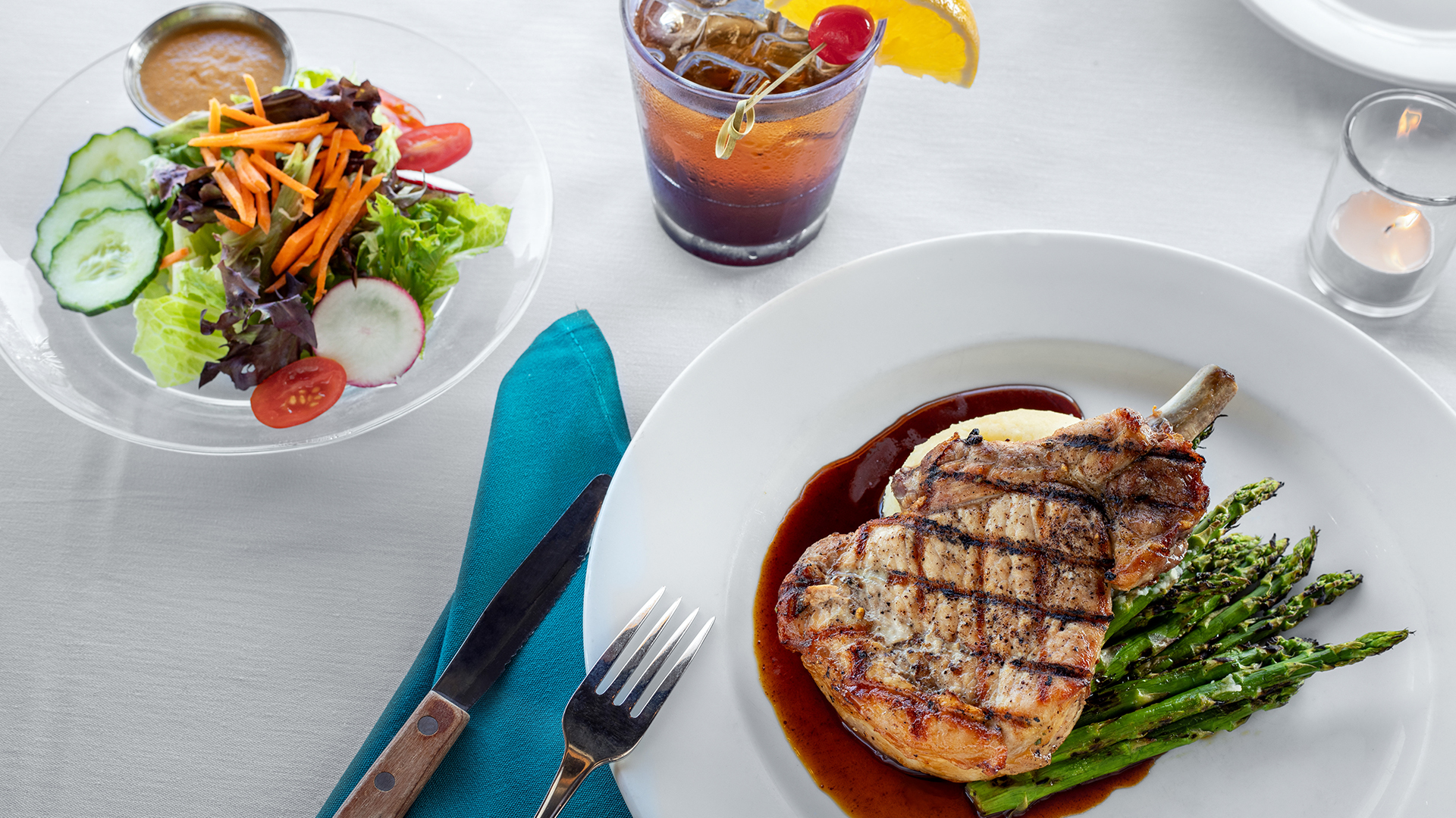 a plate of food with a drink and a glass of liquid