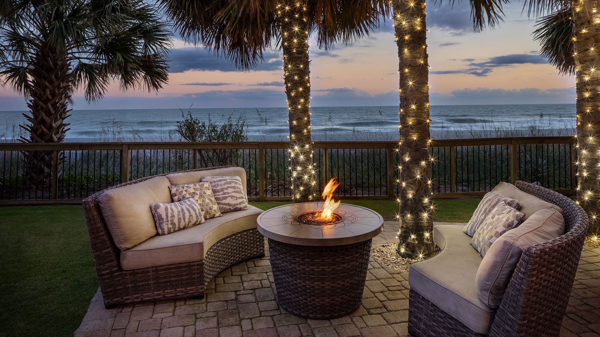 a fire pit with lights on the trees