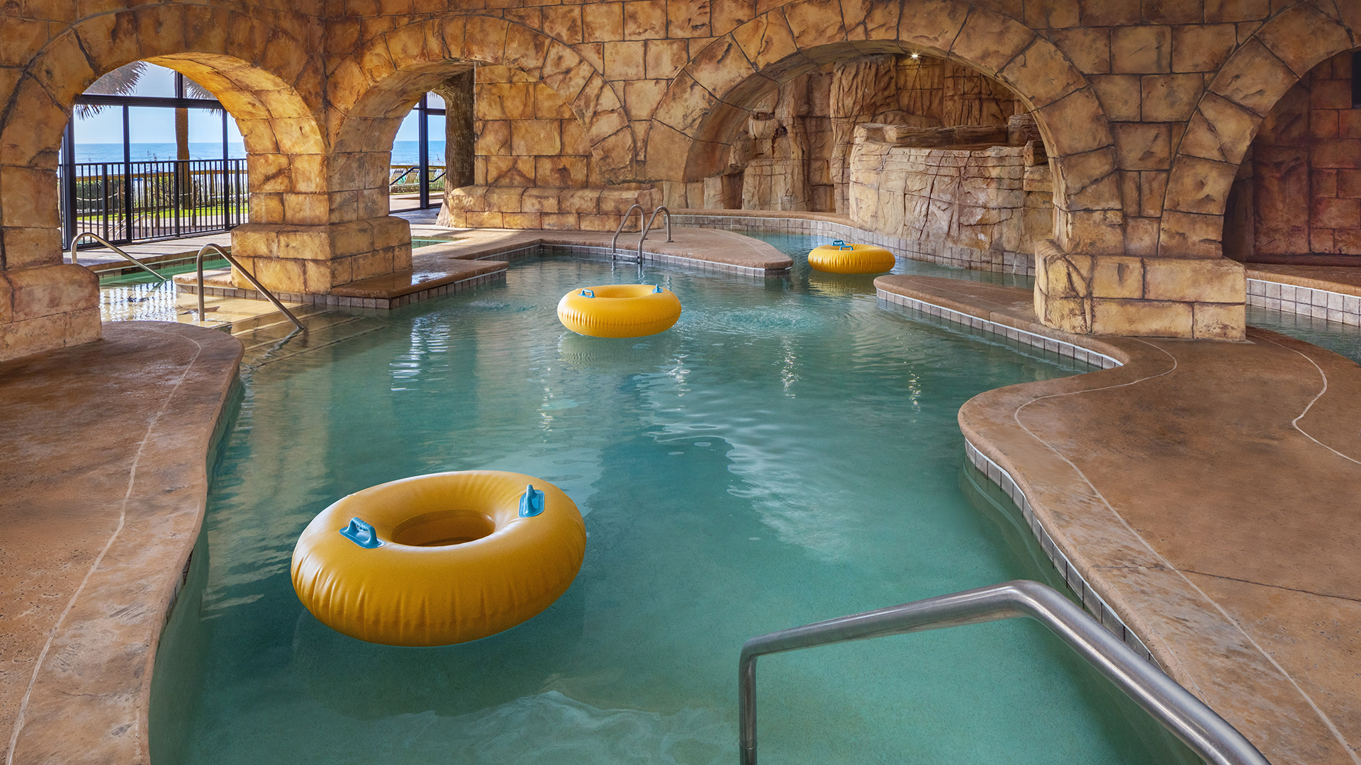 a pool with yellow tubes and steps