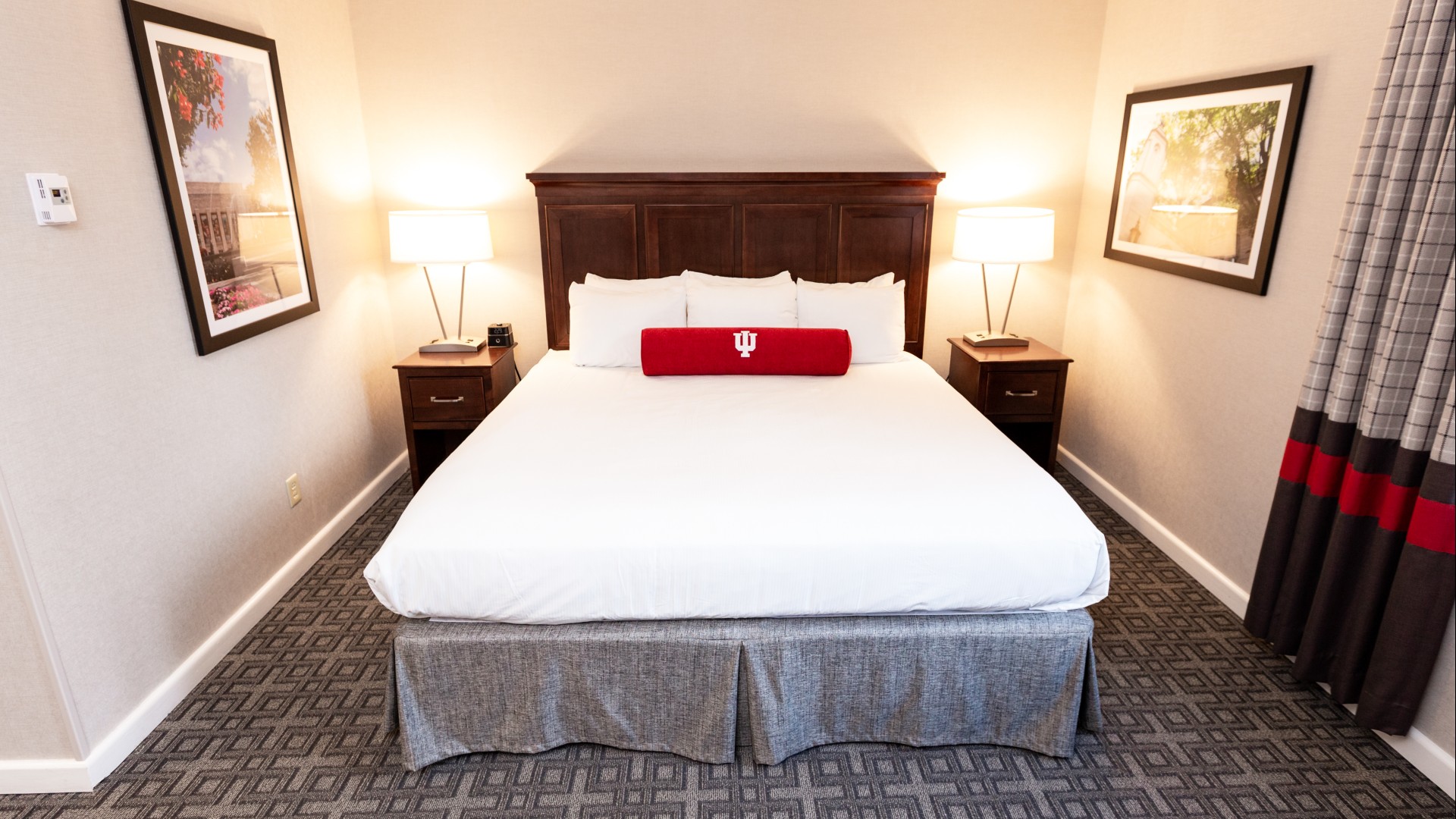 a bed with a red pillow on it