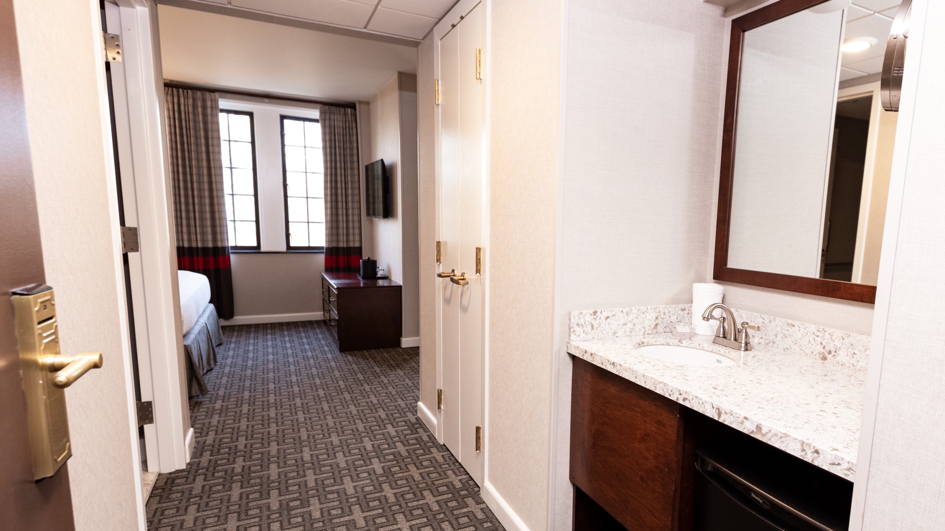 a bathroom with a bed and a mirror