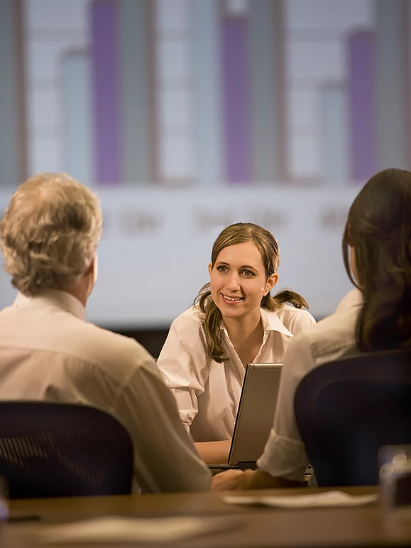 a woman sitting in front of a laptop