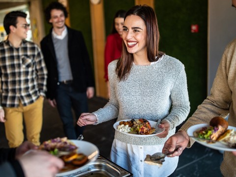 a woman holding plates of food