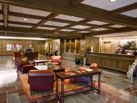 a lobby with a reception desk and chairs