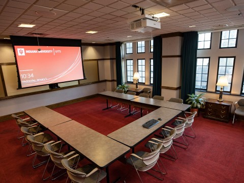 a room with a large table and chairs