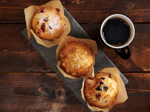 a group of muffins and a cup of coffee