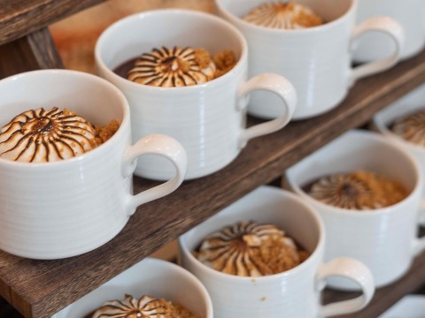 a group of white mugs with brown food in them