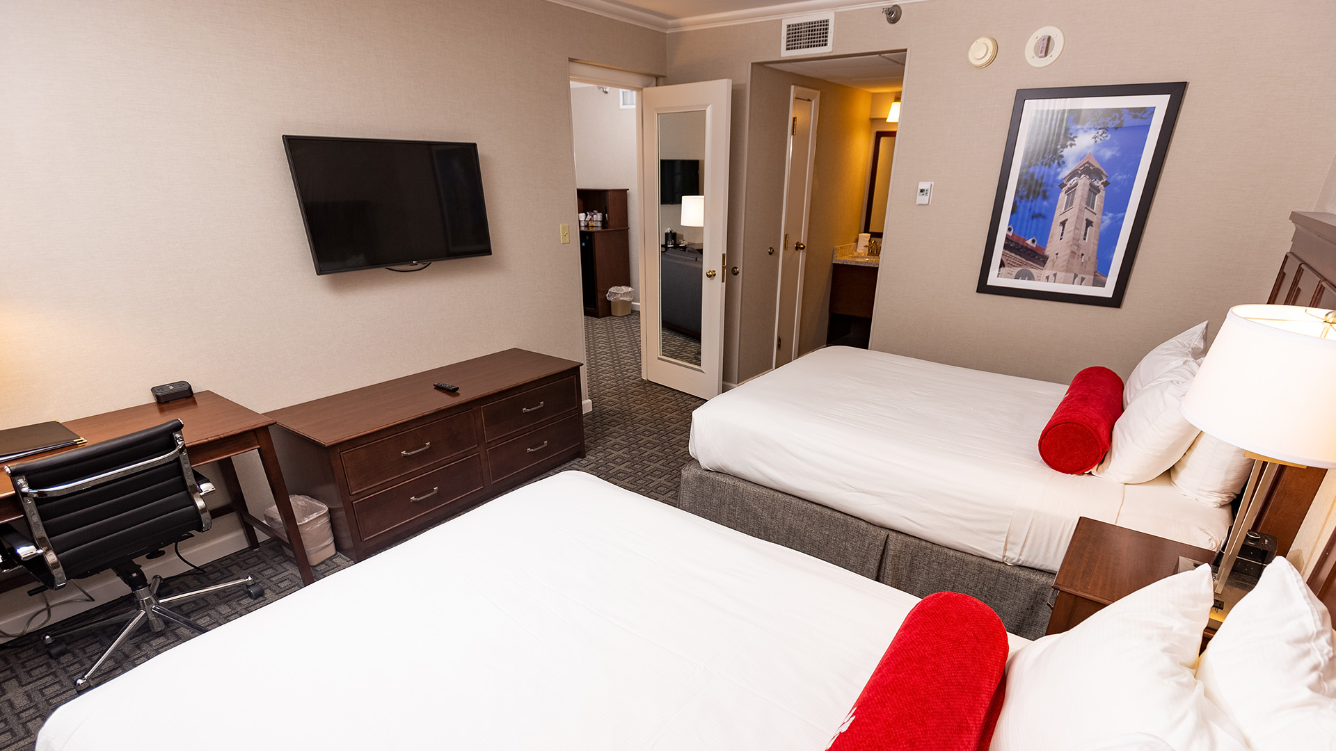 a room with two beds and a television