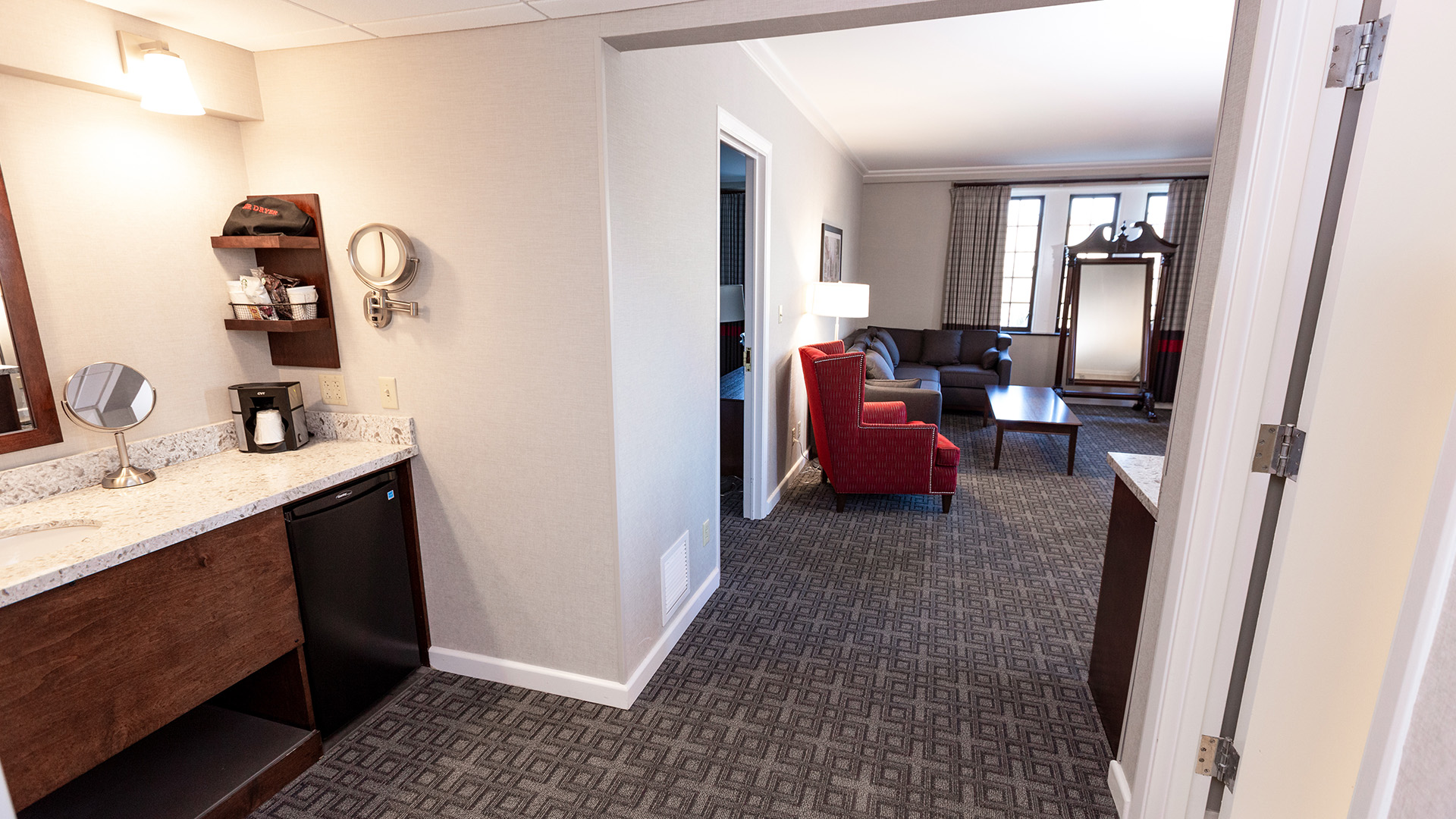 a living room with a couch and a kitchen