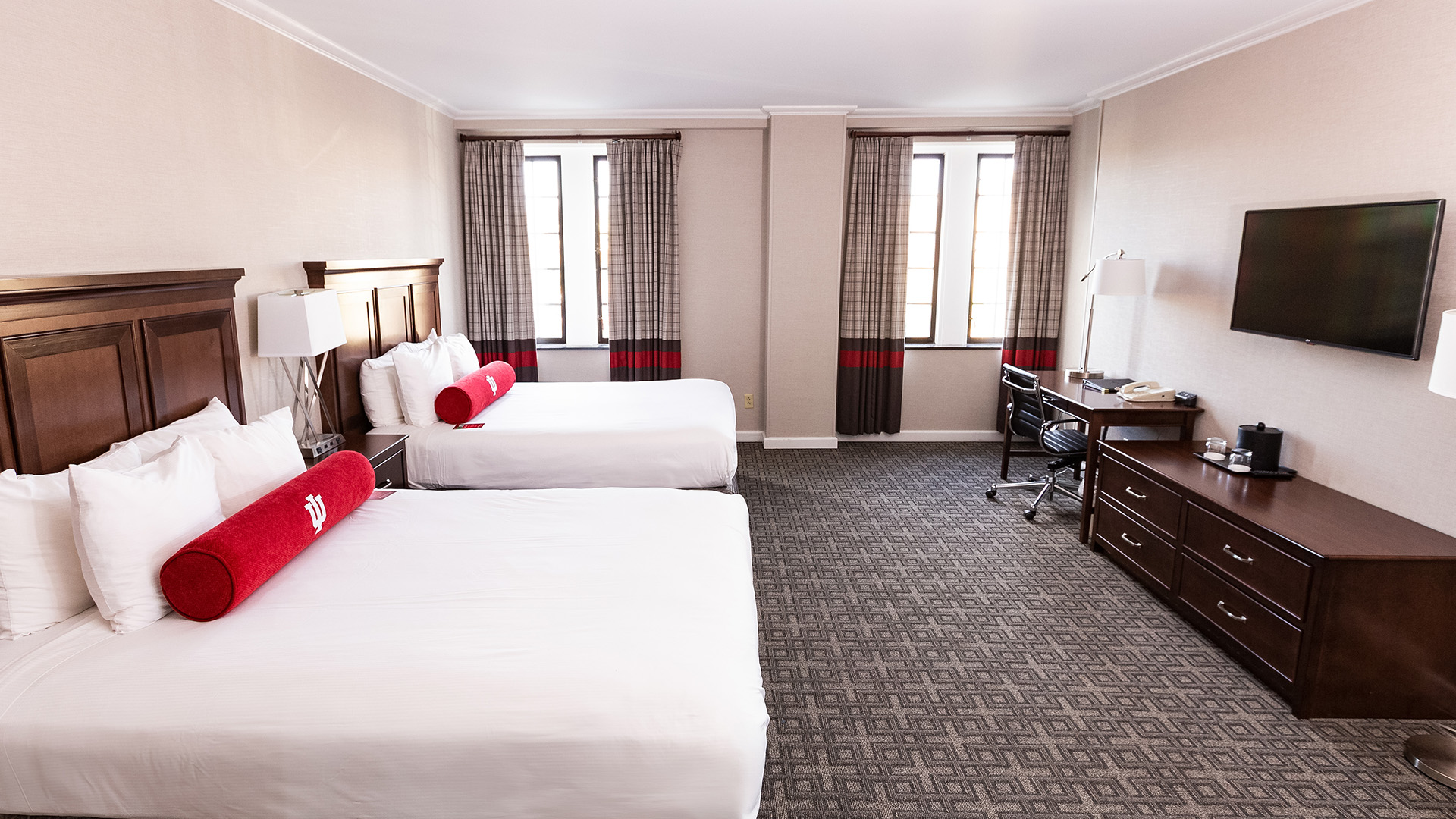 a room with two beds and a desk