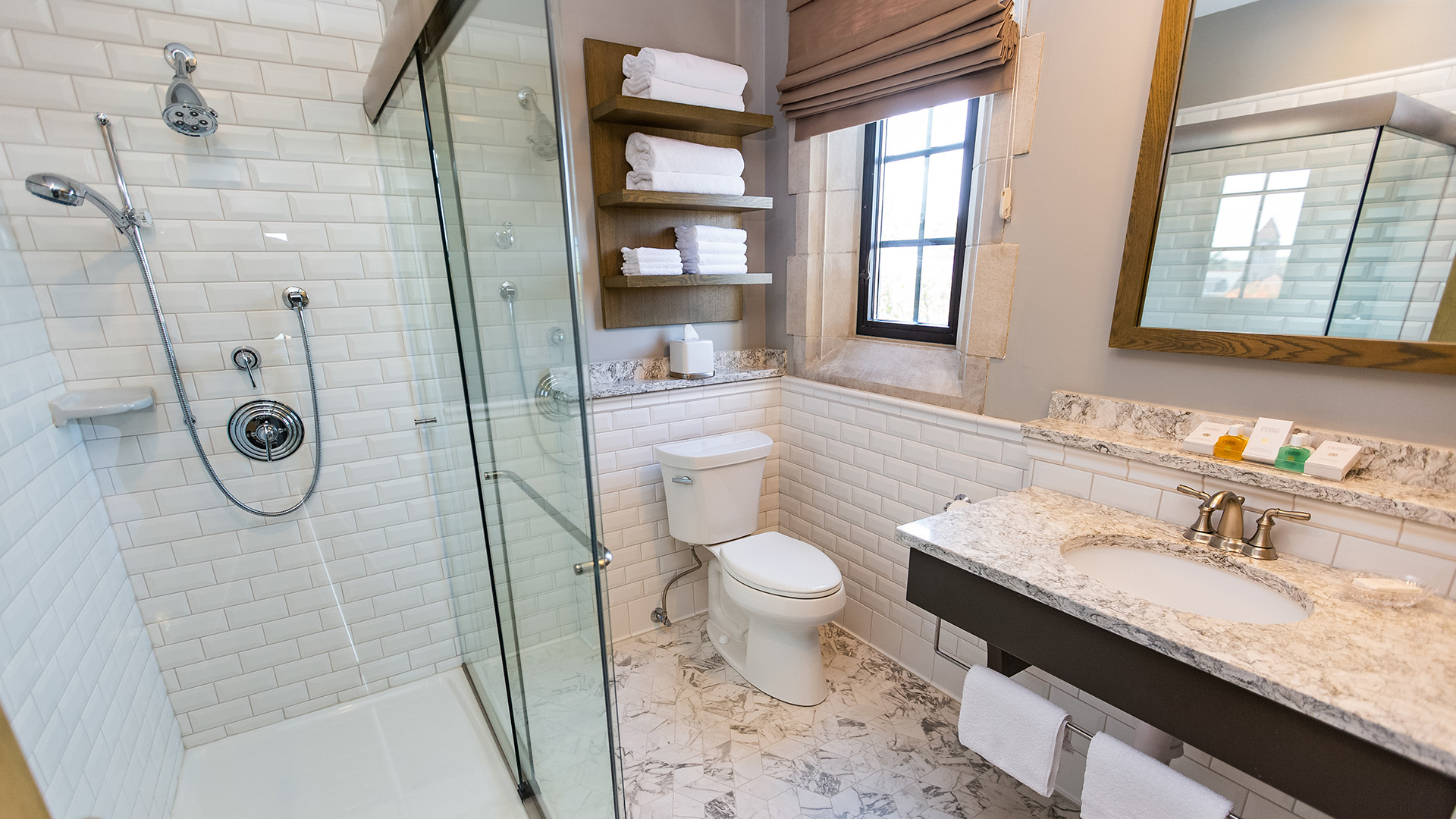 a bathroom with a glass shower and toilet