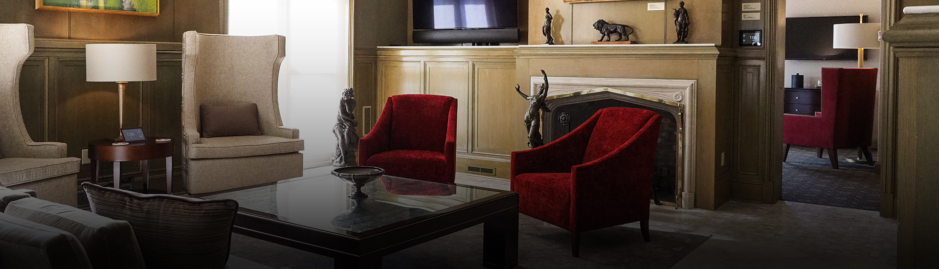 a living room with red chairs and a table