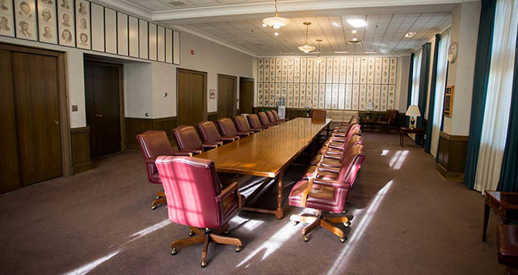 a long conference table with chairs in a room