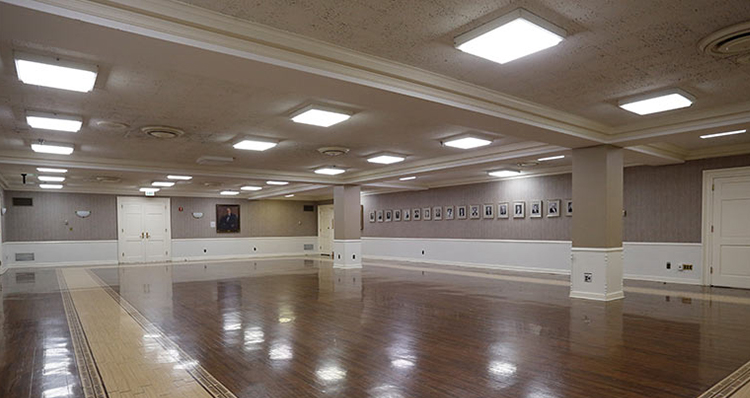 a room with a large floor and a large picture on the wall