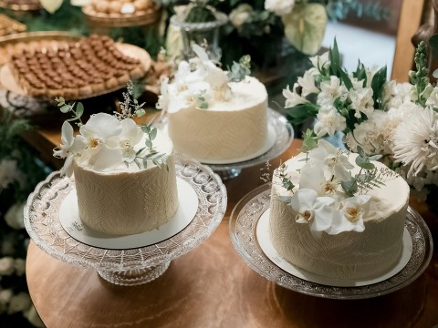 a group of cakes on plates with flowers