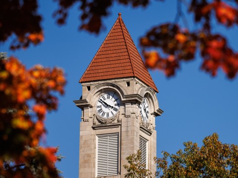 a clock tower with a red roof
