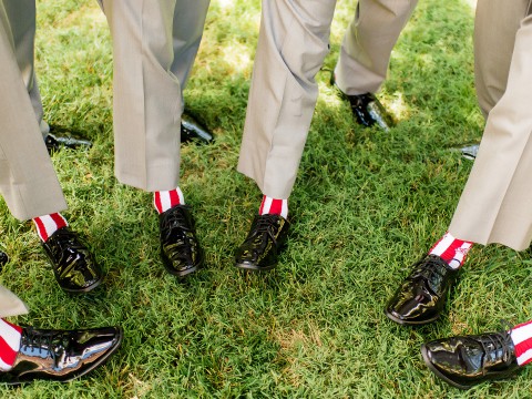 a group of men wearing black shoes and red and white socks