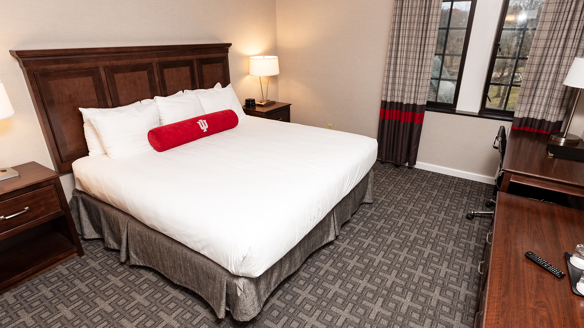 a bed with a red pillow