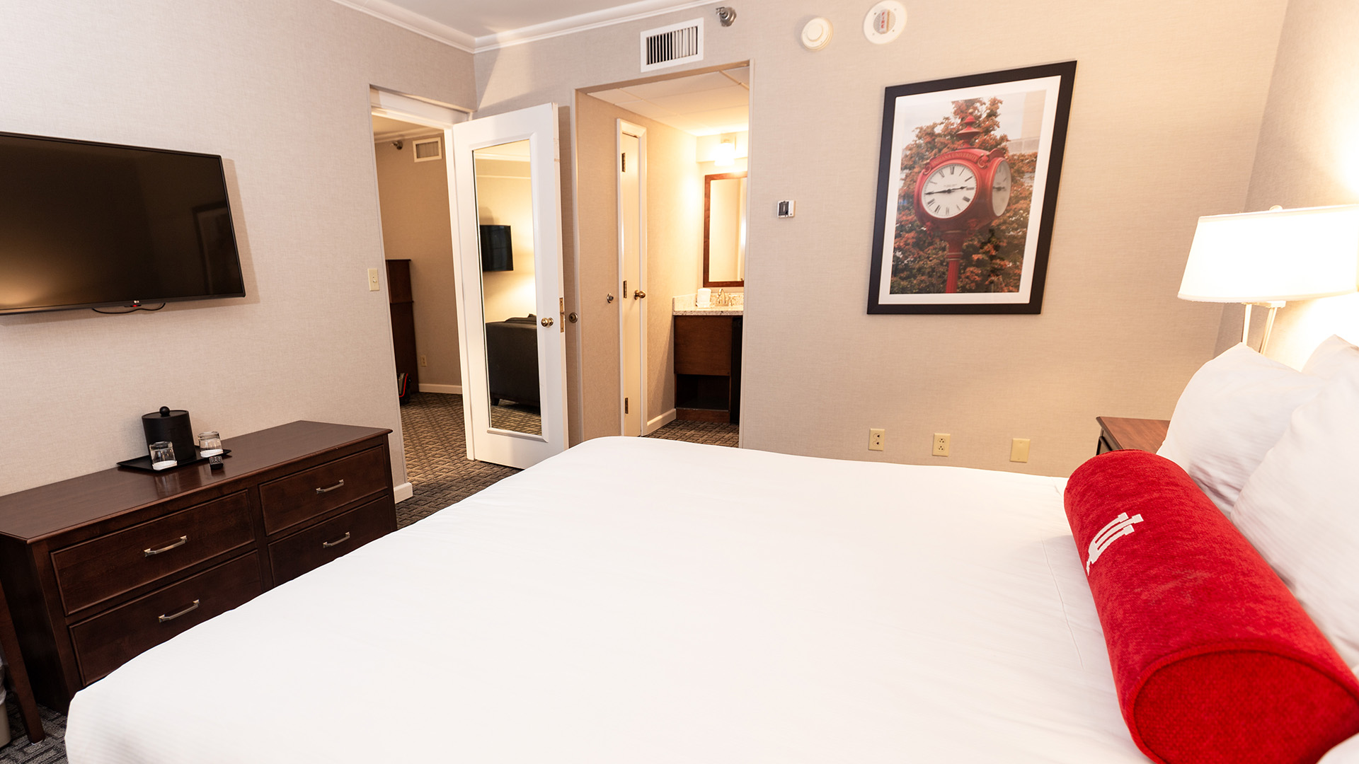 a bedroom with a bed and a mirror