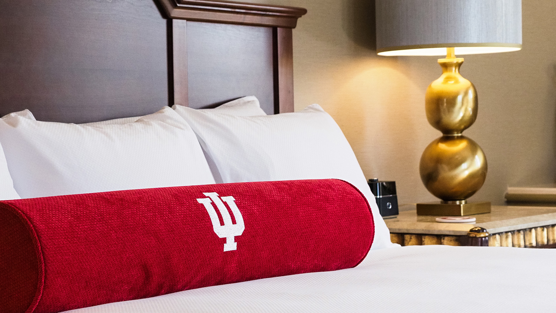 a red pillow on a bed