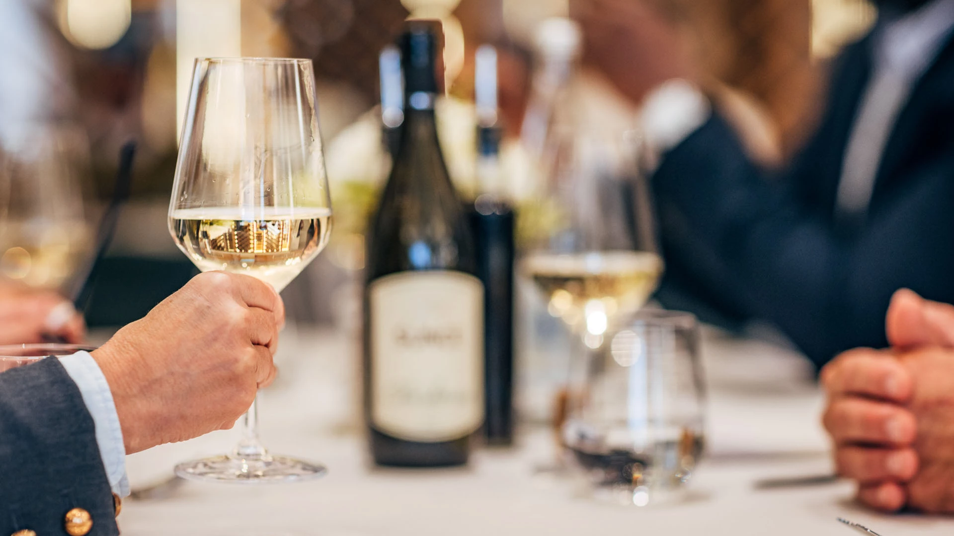 a hand holding a glass of wine