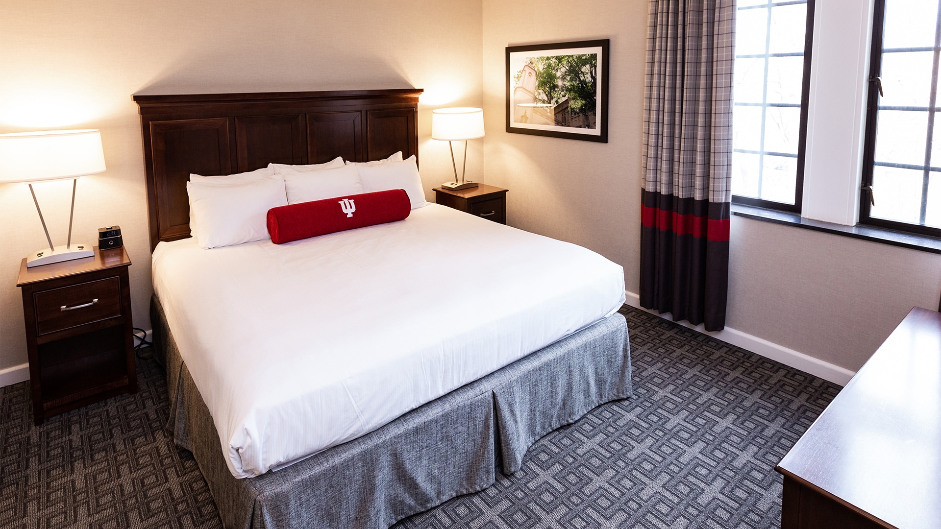 a bed with a red roll on it