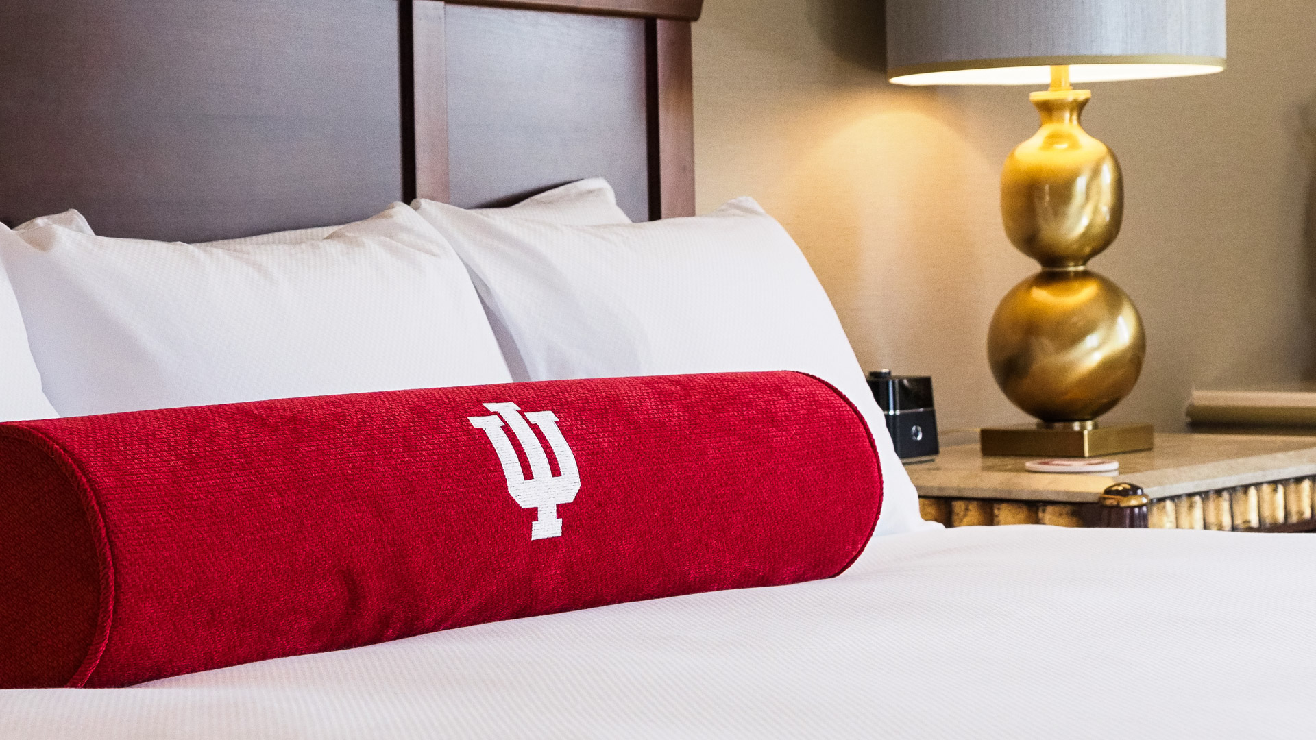 a red pillow on a bed