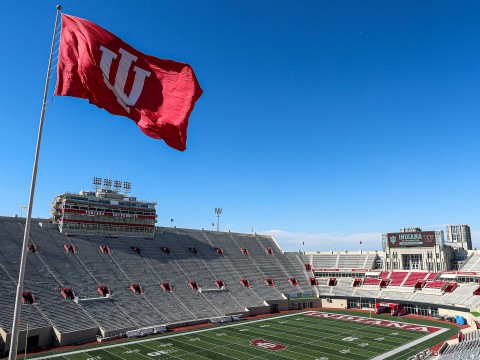 a stadium with a flag flying over it