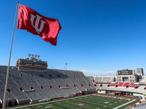 a stadium with a flag flying over it
