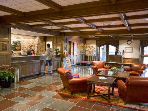 a lobby with a reception desk and chairs