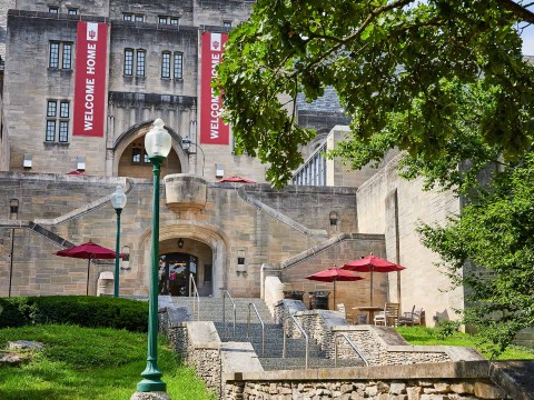 a building with stairs and umbrellas