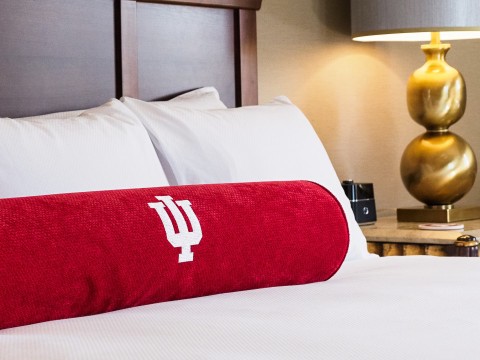 a red pillow on a bed