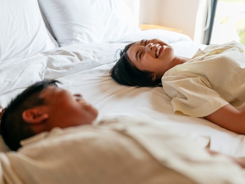 a man and woman lying on a bed