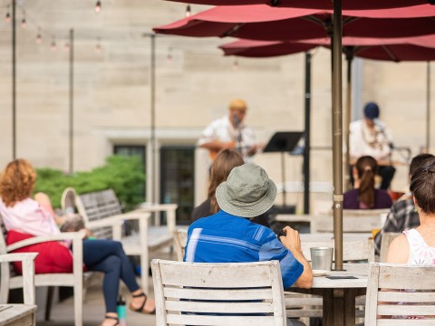 a man sitting at a table with a band playing on it