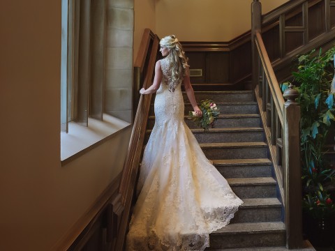 a woman in a wedding dress holding a bouquet of flowers
