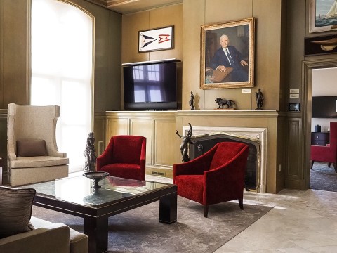 a living room with red chairs and a television