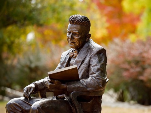 a statue of a man sitting in a chair