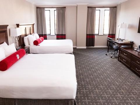 a room with two beds and a desk